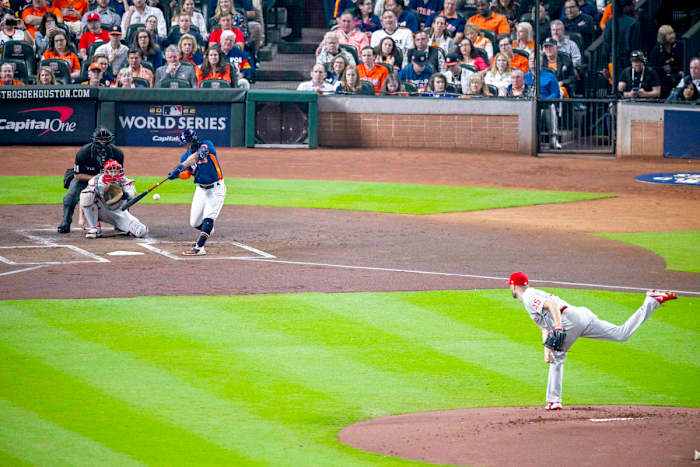 Jose Altuve hits a leadoff double in Game 2 of the World Series.